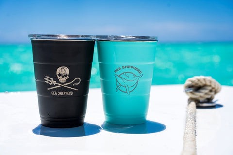 Branded tumblers from Sea Shepherd on a boat by the sea