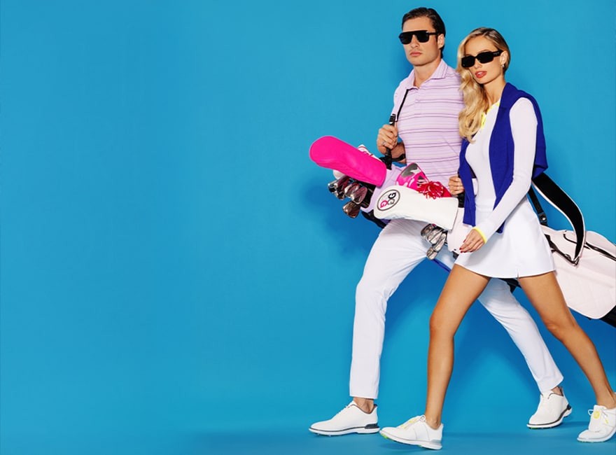 Golfers carrying branded golf bags and apparel